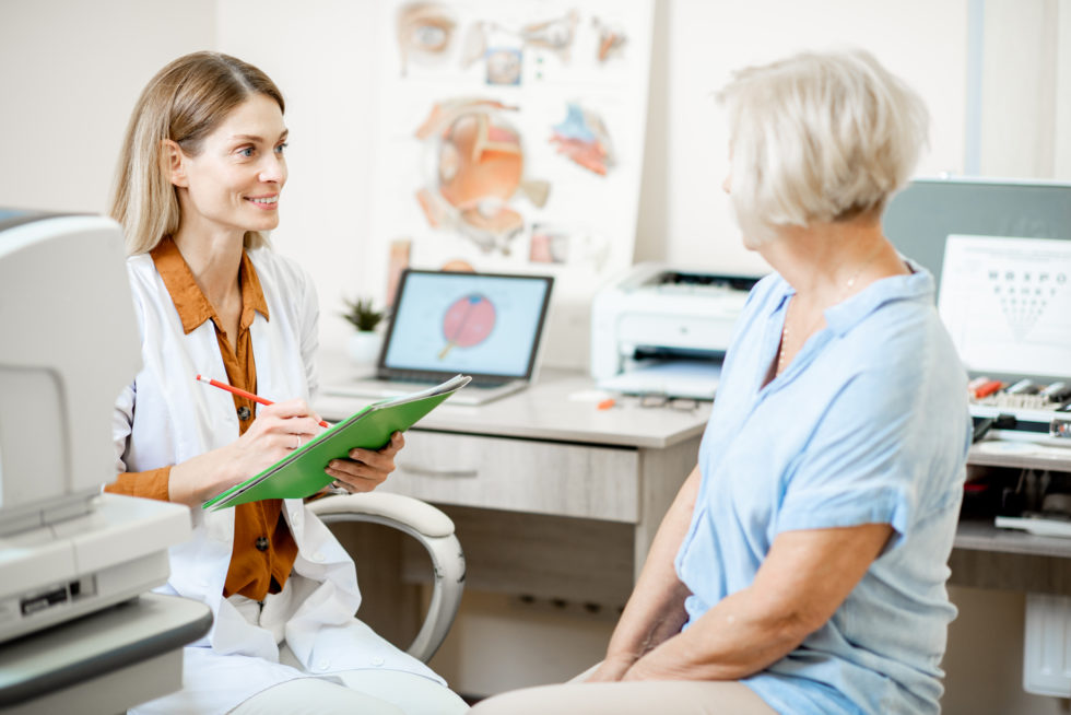 eye doctor with her old aged patient