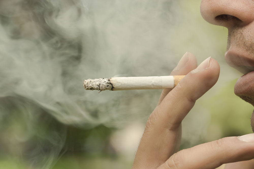 man smoking a cigarette